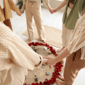 women holding hands in a circle of roses
