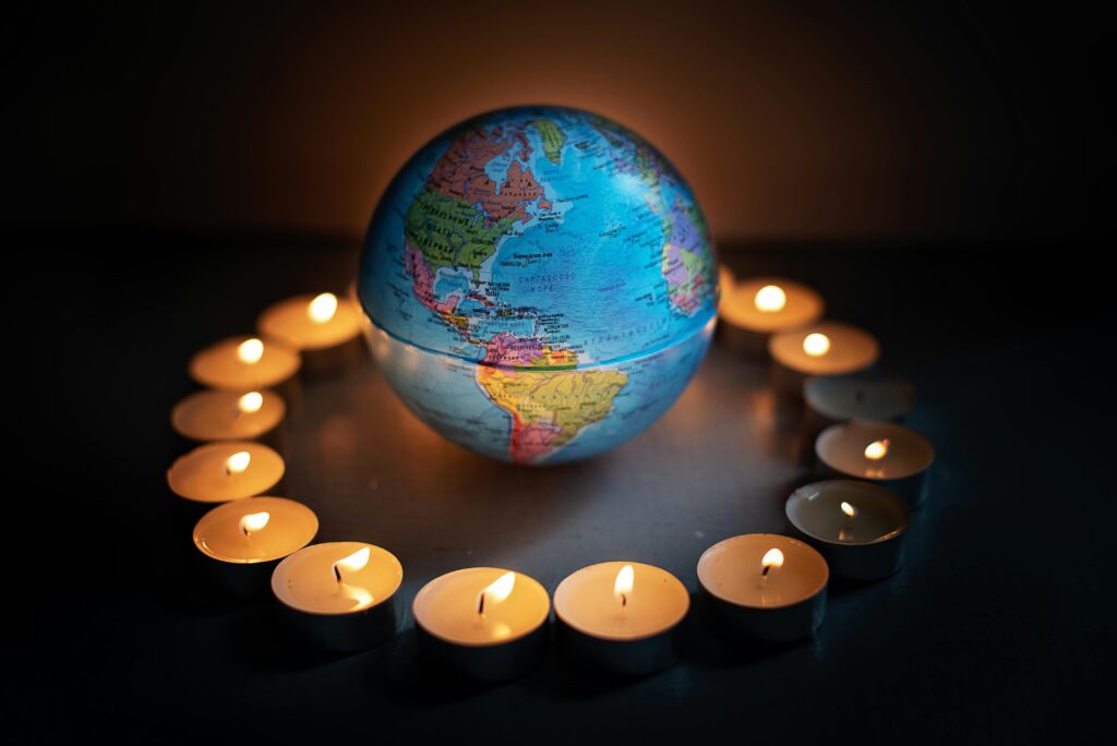 Close-Up Shot of a Globe and Lighted Candle